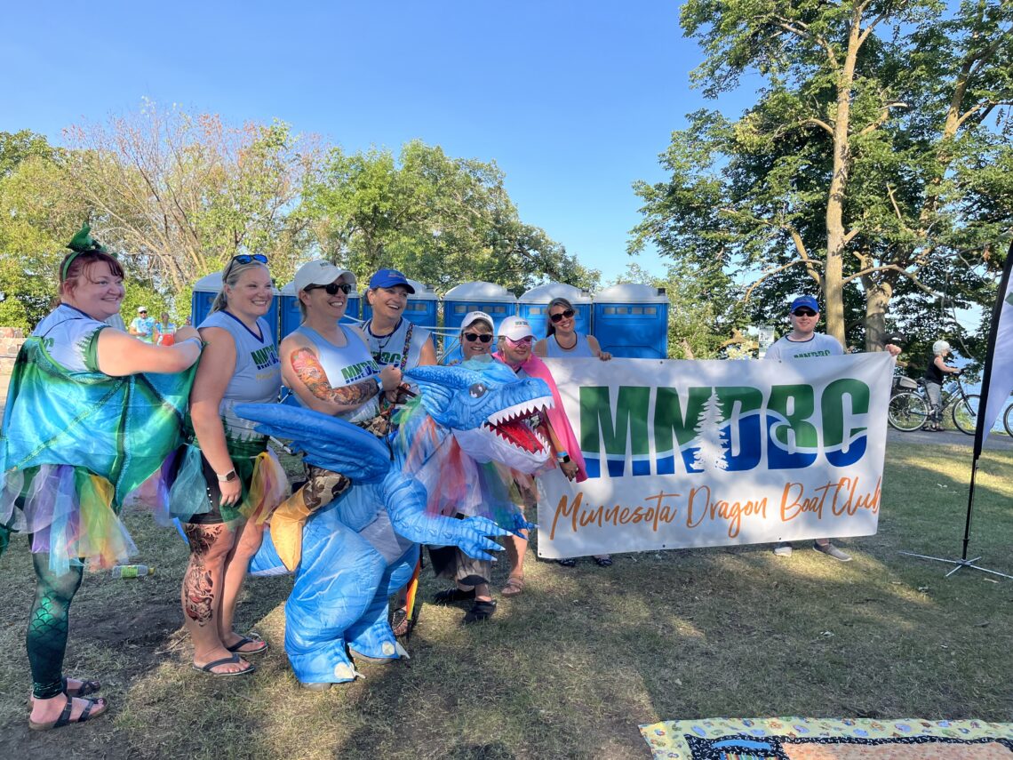 MNDBC club members in parade. Highlight is club member Kristine dressed in an inflatable dragon costume in which she is the rider of the dragon.